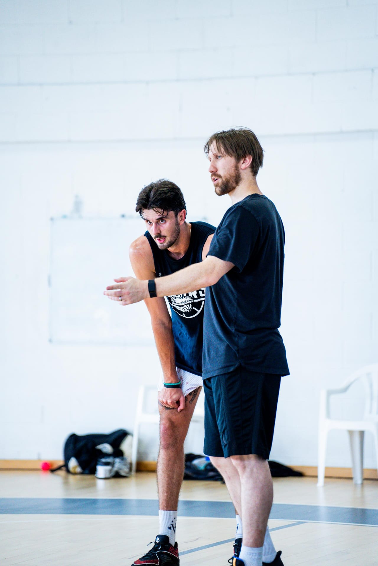 A Hoop33 coach giving direct feedback to a player on the court