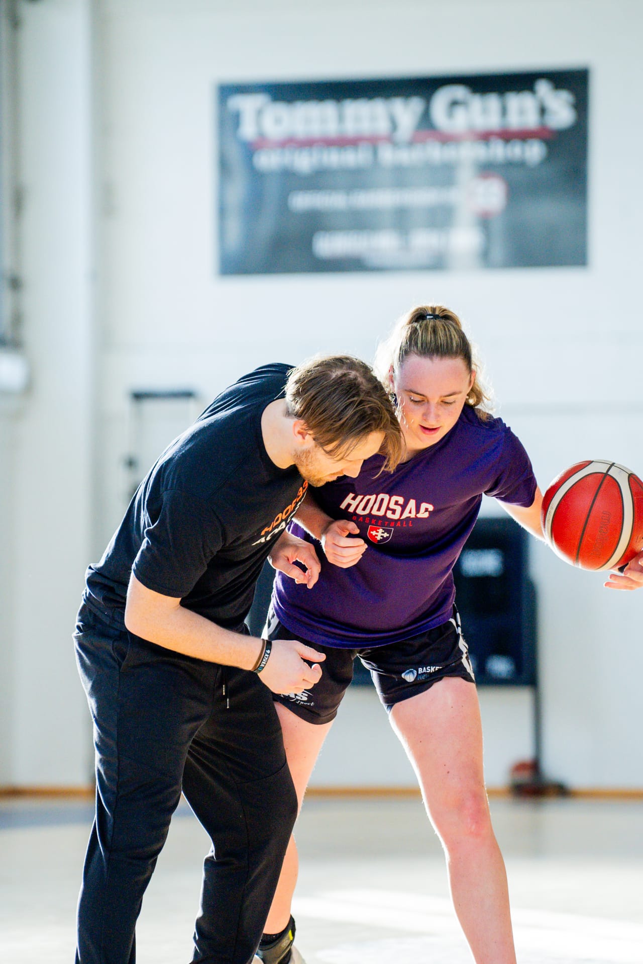 A Hoop33 coach working a player through a close-contact defence drill