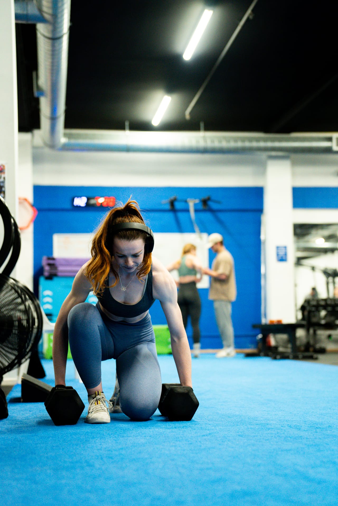 An athlete performing a weighted strength exercise in the performance gym