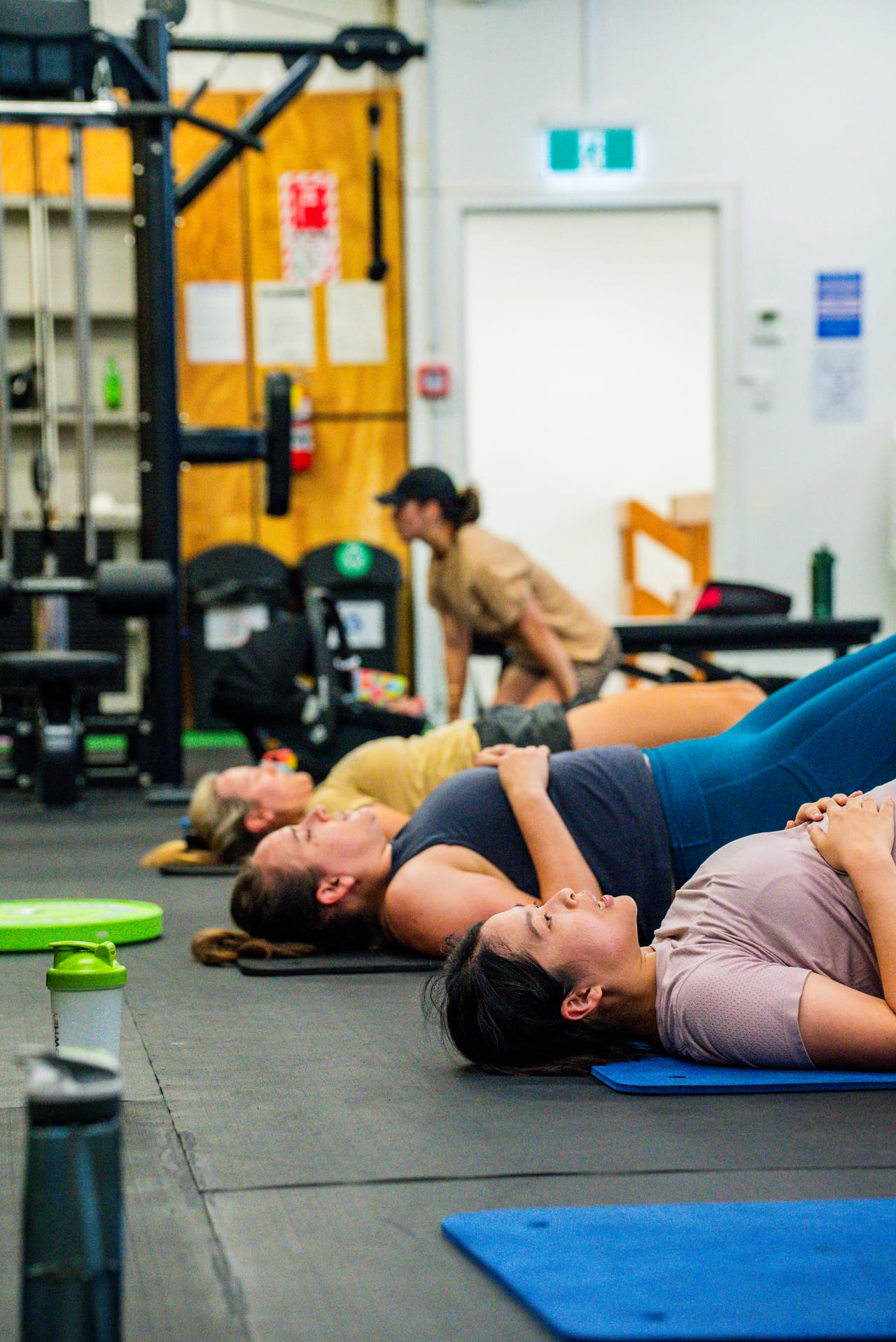 A Hoop33 group class working through a core circuit on the floor
