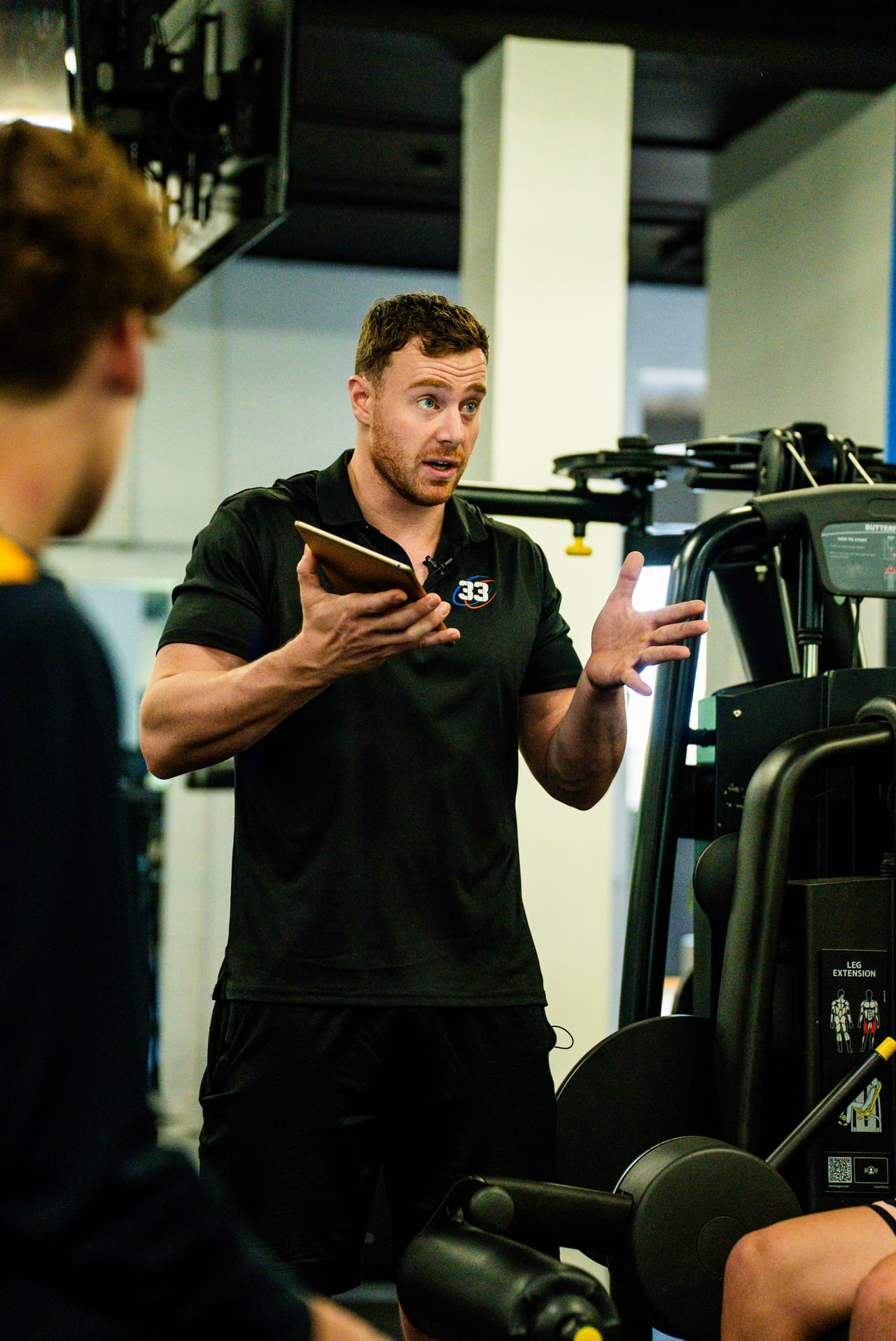 Logan Botica coaching an athlete in the performance gym