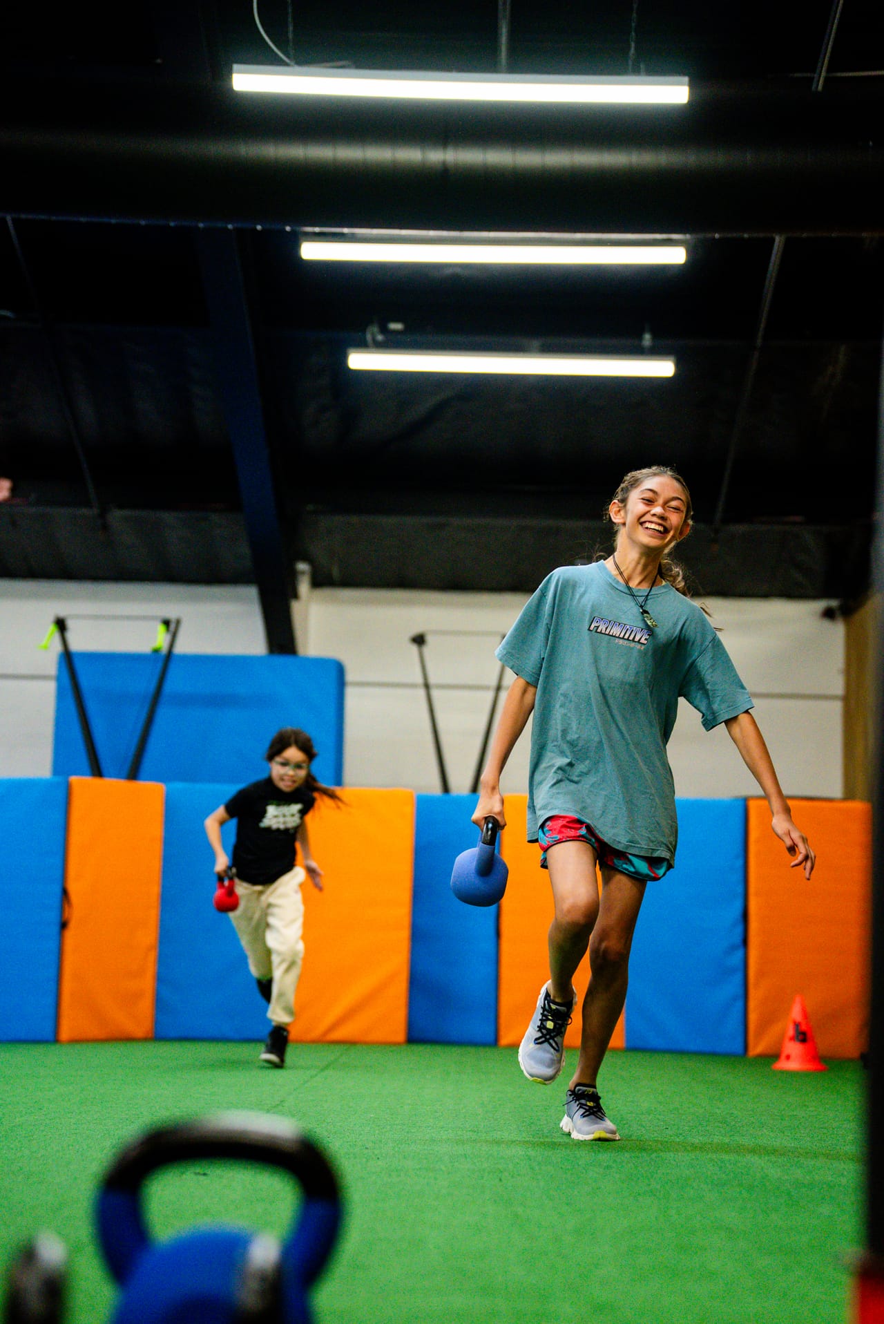 A young athlete training with a kettlebell at the Junior Movement Academy