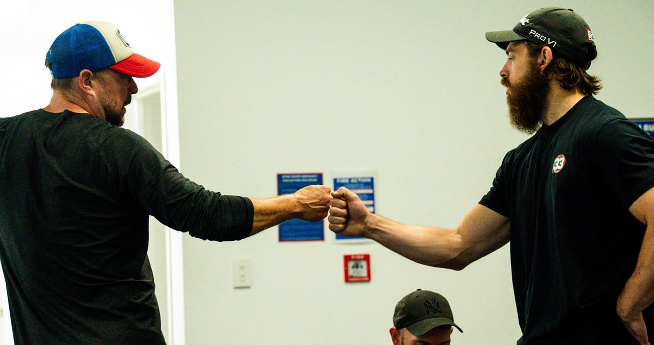 A Hoop33 coach and a member bumping fists at the end of a personal training session